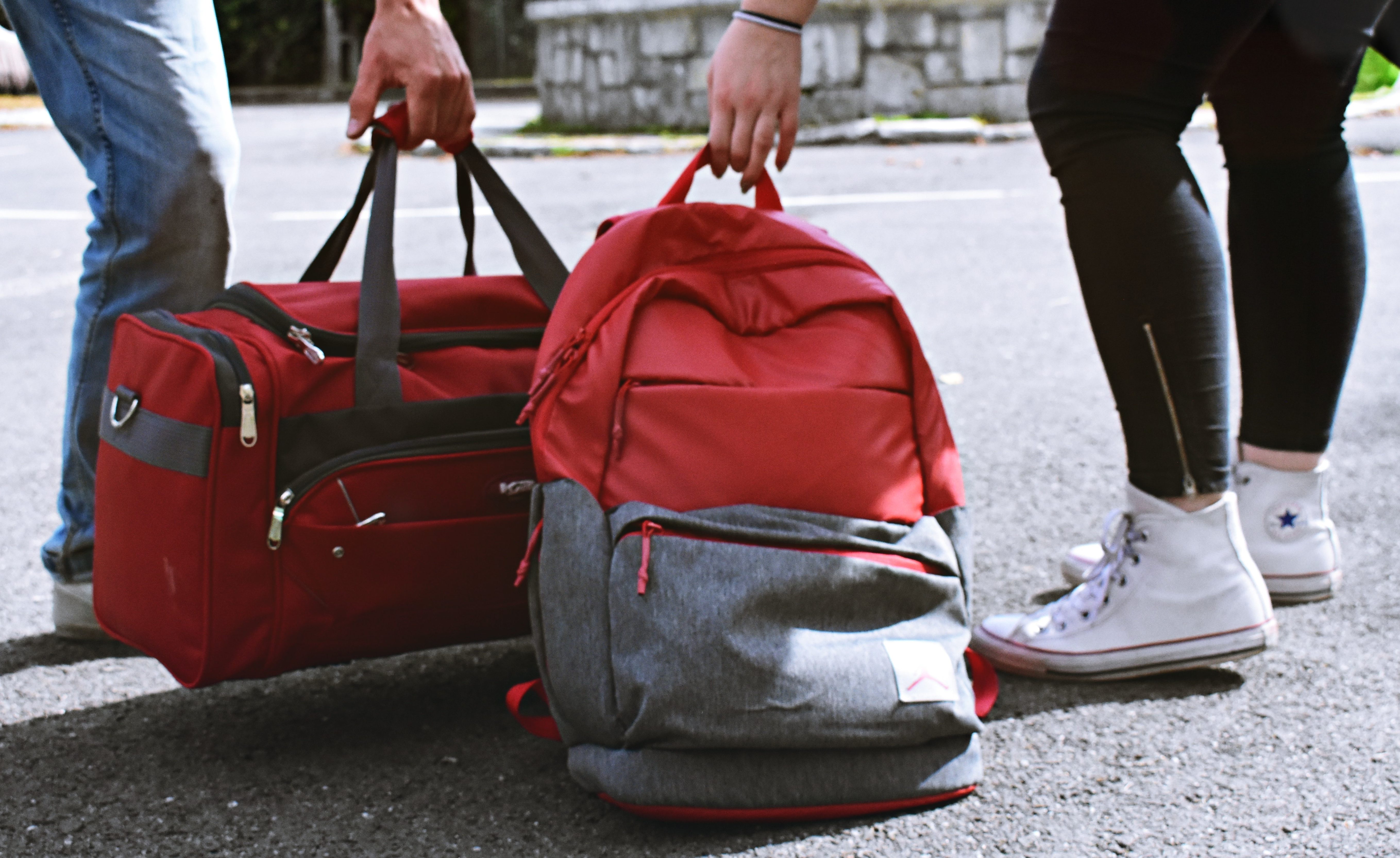 two-person-carrying-duffel-and-backpack-1986996