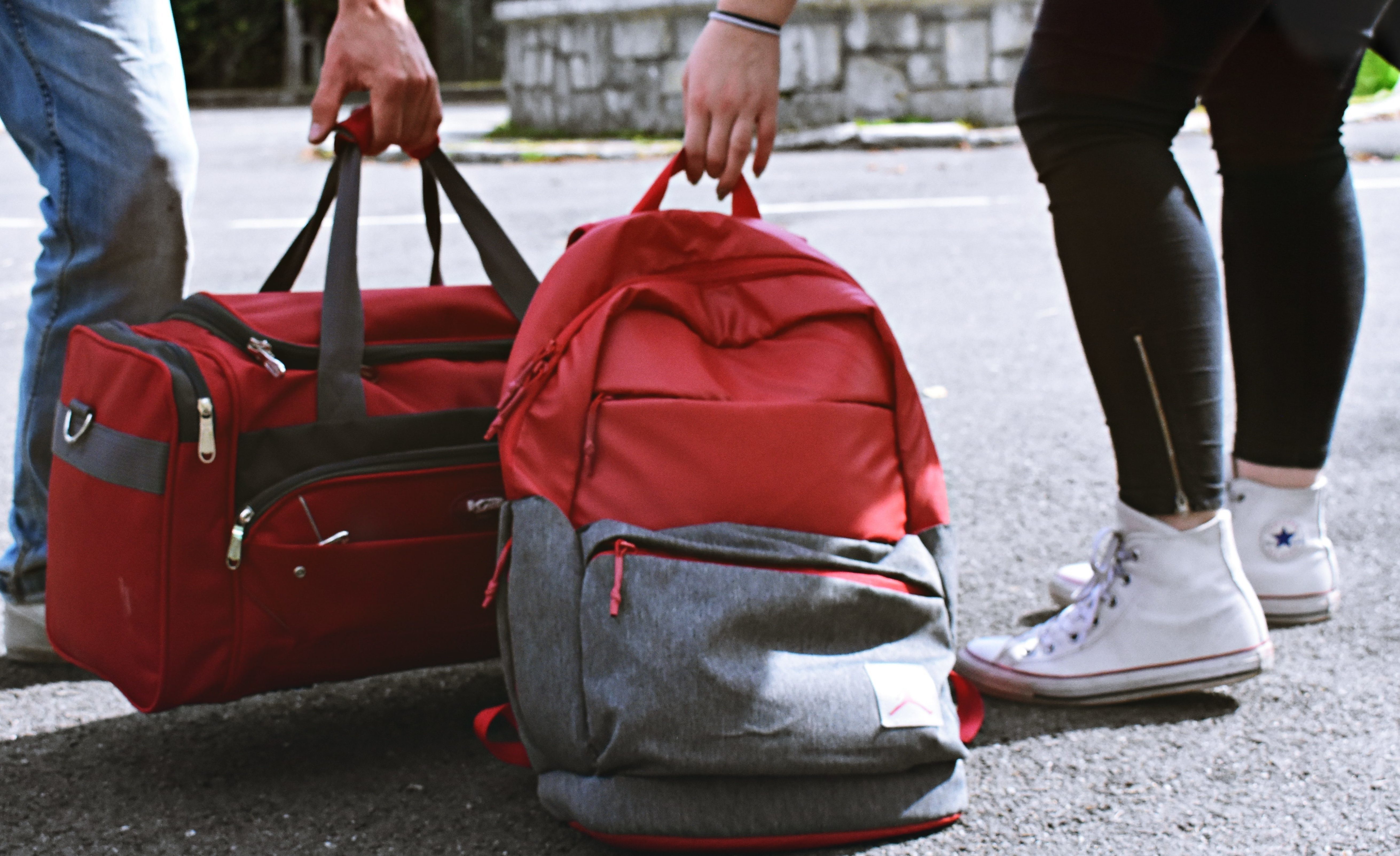 two-person-carrying-duffel-and-backpack-1986996